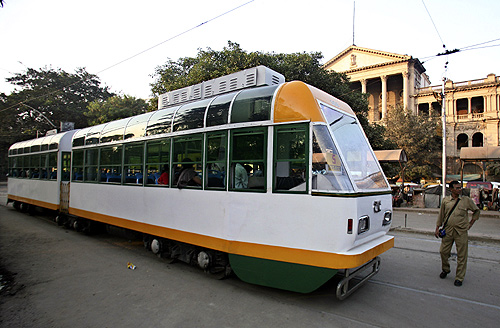 A conductor stands beside a new tram in Kolkata.