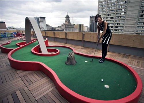 Google employee Andrea Janus demonstrates the use of the mini-putt green on the balcony at the new Google office in Toronto.
