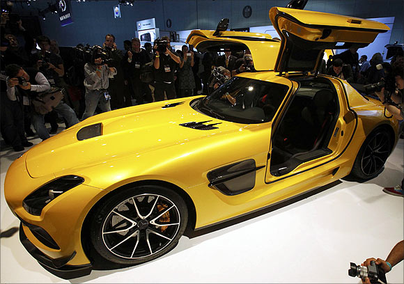 Photographers take pictures of the 2013 Mercedes-Benz SLS AMG gull wing car at the 2012 Los Angeles Auto Show in Los Angeles, California.