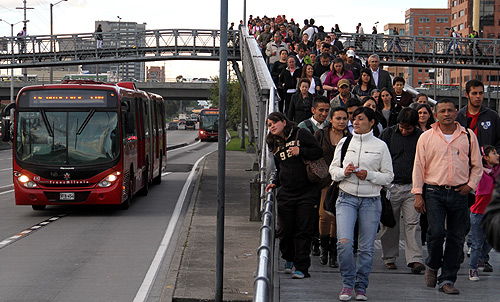 Passengers descend from a transmilenio station in a central avenue in Bogota.