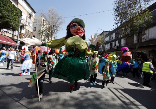 Israeli dressed in costumes take part in an annual parade for the Jewish holiday of Purim in the Israeli city of Holon, near Tel Aviv.