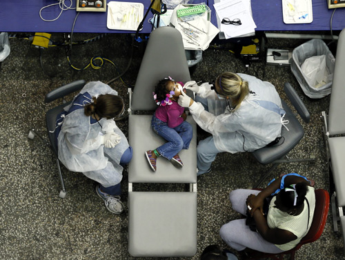 Kamora Cyprian, 2, has a dental exam at the Care Harbor/LA free clinic in Los Angeles.