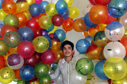 An Afghan man holds balloons for sale near the National Stadium in Kabul.