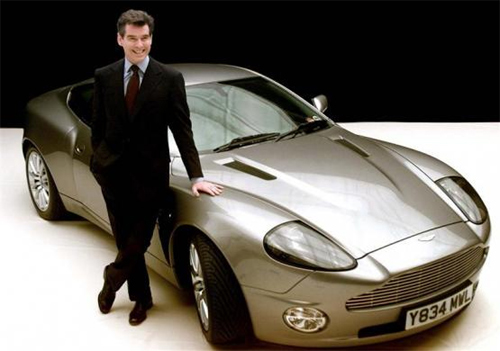 James Bond actor Pierce Brosnan poses for photographers with the Bond car, an Aston Martin V12 Vanquish, at Pinewood Studios in London.
