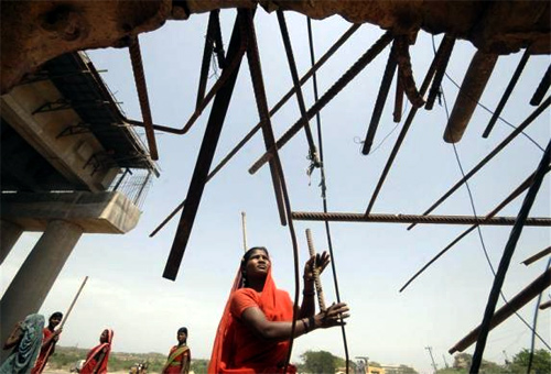 A woman labourer works at a road construction site on the outskirts of Hyderabad.