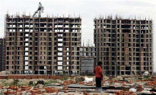 Labourers work at the construction site of a residential complex on the outskirts of New Delhi.