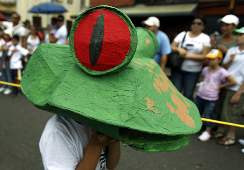 A student wears a frog mask during Costa Rica's Independence Day celebrations in San Jose.