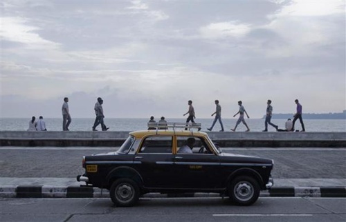 A driver waits for customers in his Premier Padmini taxi on Marine Drive in Mumbai.