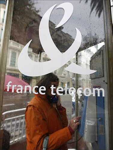 A woman makes a phone call in a France Telecom phone box in Nice, southern France.