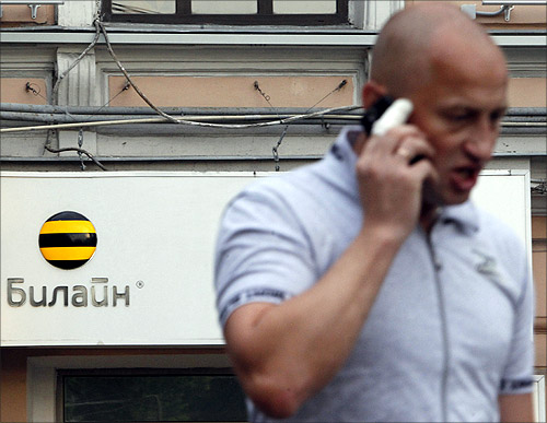 A man speaks on the phone near an office of Beeline, the brand owned by mobile phone operator Vimpelcom, in Moscow.