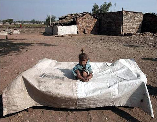 A malnourished Sahariya tribe child is seen outside his house at Kasbathana village in Baran district in Rajasthan.