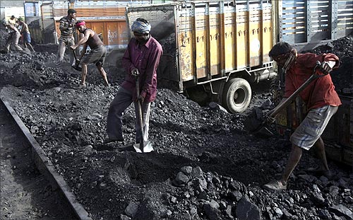 Labourers load coal onto trucks at Bari Brahamina, on the outskirts of Jammu.