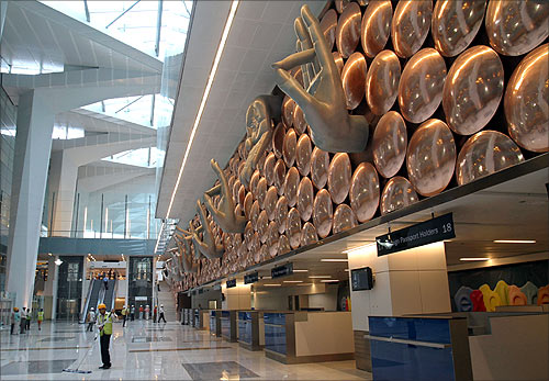 Labourers work inside the newly constructed Terminal 3 at Indira Gandhi International Airport in New Delhi.