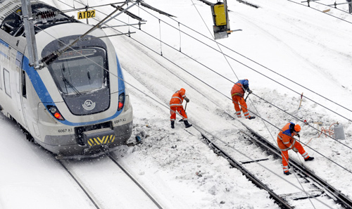 Railway workers tries to clear points from ice and snow at the marshalling yard at the Central Station in Stockholm.
