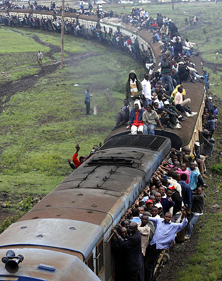 Passengers ride atop overloaded carriages of a commuter train in Kenya's capital Nairobi.
