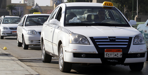 New white taxis are seen on a road in downtown Cairo.