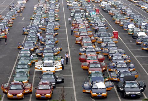 Taxi drivers queue at a parking lot while waiting for passengers at the new Beijing Capital International Airport.