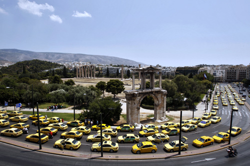 Stationary taxis are seen in front of Athens' Hadrian Gate during a protest in Athens.