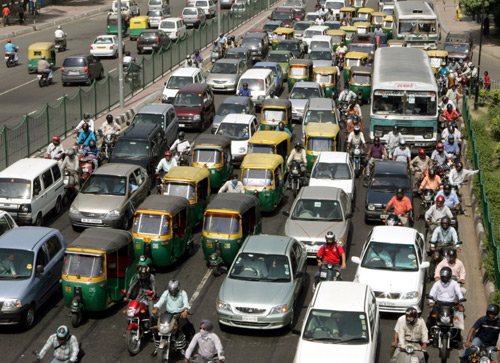 Traffic moves at a slow pace on a street of New Delhi.