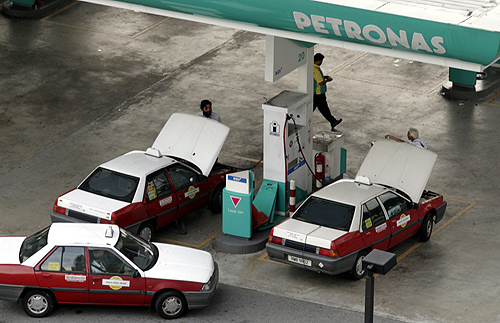 Taxis pump natural gas at a Petronas station in Kuala Lumpur.