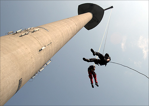 A police officer and a paramedic rope down the 252 metres (827 feet) high Donauturm tower, Austria's tallest building, during a joint exercise in Vienna.