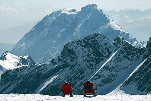 Two unidentified tourists enjoy the sun in the skiing resort of Garmisch Partenkirchen on top of Germany's highest mountain Zugspitze, about 60 kilometres south of Munich.