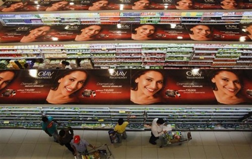 People shop down the aisles of a supermarket in Mumbai.
