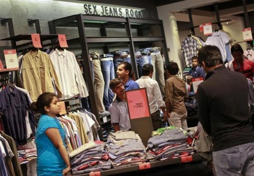 People shop for clothes at a store during a seasonal sale inside a shopping mall in Mumbai.
