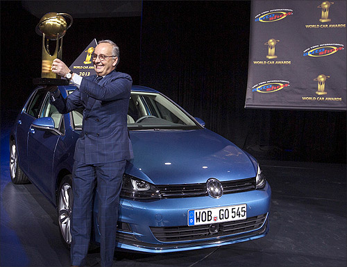 Volkswagen design chief Walter de Silva holds a trophy after the Volkswagen Golf was named 2013 World Car of the Year during the New York International Auto Show in New York.