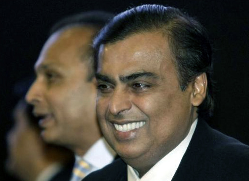 Mukesh Ambani (R), chairman of Reliance Industries, smiles as his brother Anil Ambani, chairman of Reliance Group, stands behind him during the inauguration ceremony of the Vibrant Gujarat global investor summit at Gandhinagar.