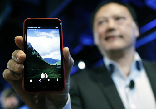 HTC CEO Peter Chou holds an HTC First phone showing the new app Facebook Home for Android during a press event in Menlo Park, California.