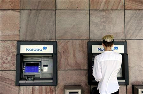 A customer makes a withdrawal from a Nordea automatic teller machine in Stockholm.