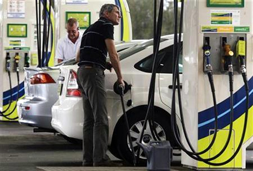 A man refuels his car at a petrol station in Sydney.