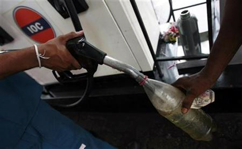 A worker fills up a bottle at a Lanka India Oil fuel station in Colombo.