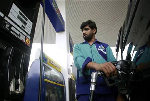 A service station attendant fills a car with fuel at a petrol station in Islamabad.