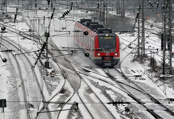A regional train travels along snow-covered rails near Essen in Germany.
