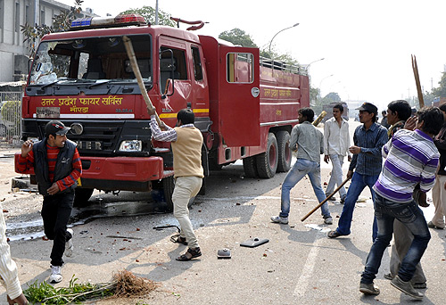 Protesters damage a fire engine during a strike in Noida, on the outskirts of New Delhi.