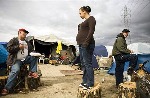 Rob Bennett (L), Kami Ballard (C), and James Meece at a homeless tent city in Sacramento, California.