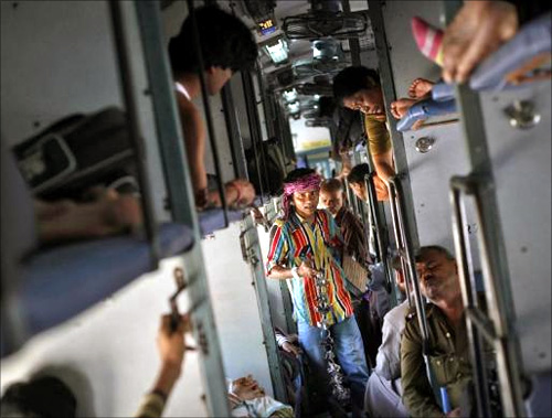 A man sells locks and chains inside a compartment of the Kalka Mail passenger train on the way to Kolkata.
