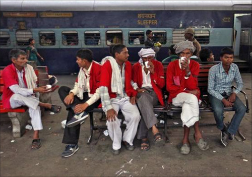 Porters rest in front of the Kalka Mail passenger train at a railway station in the old quarters of Delhi.