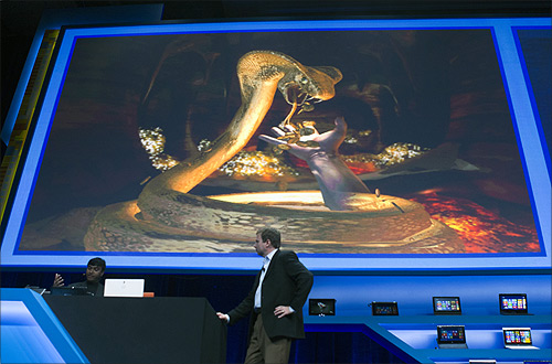 Achin Bhownik (L) demonstrates a computer game with conceptual computing features to Kirk Skaugen, vice president of PC client group for Intel, during an Intel press conference during the Consumer Electronics Show (CES) in Las Vegas.