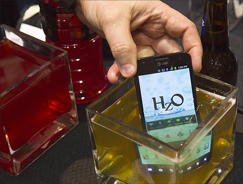 A smart phone with HzO Waterblock technology is dipped in beer at the opening press event of the Consumer Electronics Show (CES) in Las Vegas.