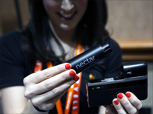 A woman demonstrates the Nectar mobile power source at the opening press event of the Consumer Electronics Show (CES) in Las Vegas.