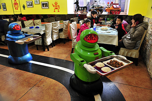 Robots deliver dishes to customers at a Robot Restaurant in Harbin, Heilongjiang province.