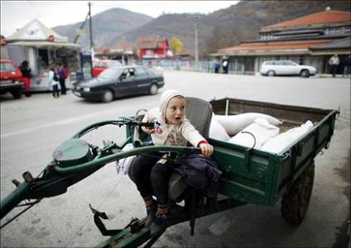 A boy waits for his father as he sits in their vehicle in the southern Serbian town of Trgoviste.