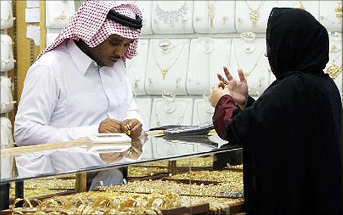 A  salesman shows a customer gold rings at a jewellery shop in Riyadh.