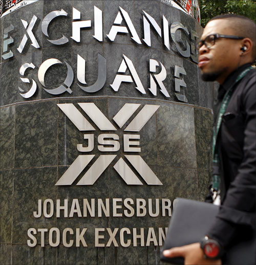 A man walks past the Johannesburg Stock Exchange building in Sandton.