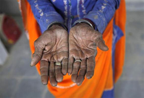 Radha, 75, a vegetable vendor poses with her hands after she got her fingerprint scanned for the Unique Identification (UID) database system at an enrolment centre at Merta district in Rajasthan.