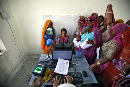 Village women stand in a queue to get themselves enrolled for the Unique Identification (UID) database system at Merta district in Rajasthan.