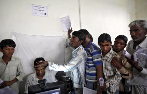 Villagers stand in a queue to get themselves enrolled for the Unique Identification (UID) database system at Merta district in Rajasthan.
